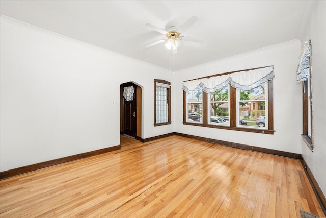 3523 W 60th Pl, Chicago, IL 60629 - unfurnished room featuring light wood-style flooring, baseboards, ceiling fan, crown molding, and arched walkways