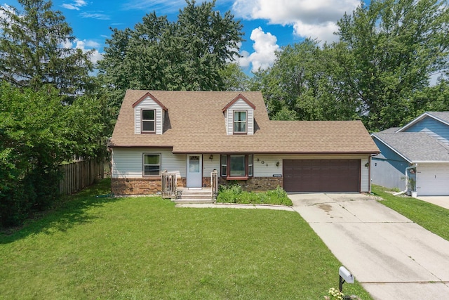 301 Columbia Dr, Normal, IL 61761 - cape cod-style house featuring a garage, brick siding, concrete driveway, and a shingled roof