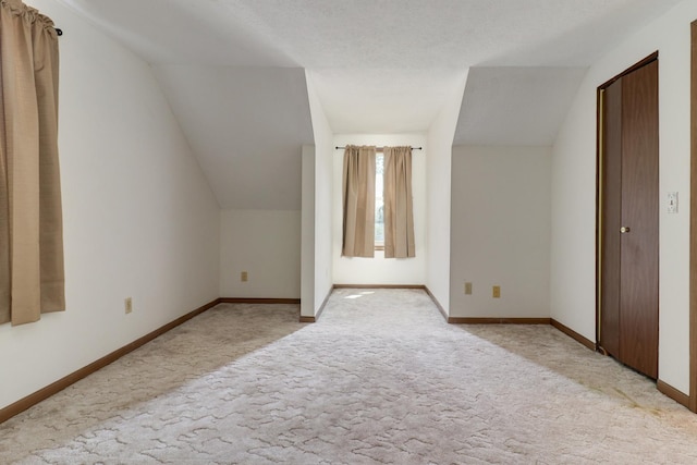 301 Columbia Dr, Normal, IL 61761 - additional living space with light colored carpet and vaulted ceiling