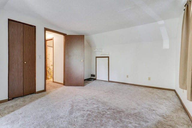 301 Columbia Dr, Normal, IL 61761 - unfurnished bedroom with carpet flooring and vaulted ceiling