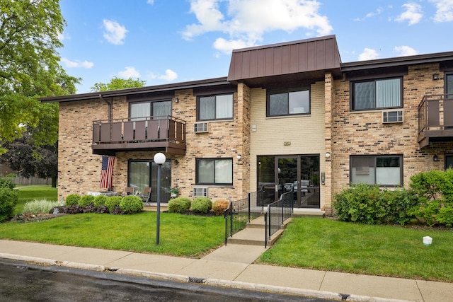 2642 N Windsor Dr Unit 102, Arlington Heights, IL 60004 - view of front of home with brick siding, a front lawn, and a balcony