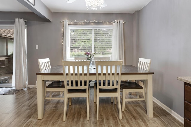 2642 N Windsor Dr Unit 102, Arlington Heights, IL 60004 - dining area featuring wood finished floors, baseboards, and a chandelier