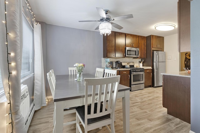 2642 N Windsor Dr Unit 102, Arlington Heights, IL 60004 - kitchen featuring appliances with stainless steel finishes, light wood-type flooring, ceiling fan, and healthy amount of natural light