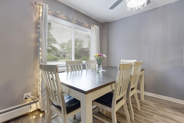 2642 N Windsor Dr Unit 102, Arlington Heights, IL 60004 - dining space with a baseboard radiator, a ceiling fan, wood finished floors, and baseboards