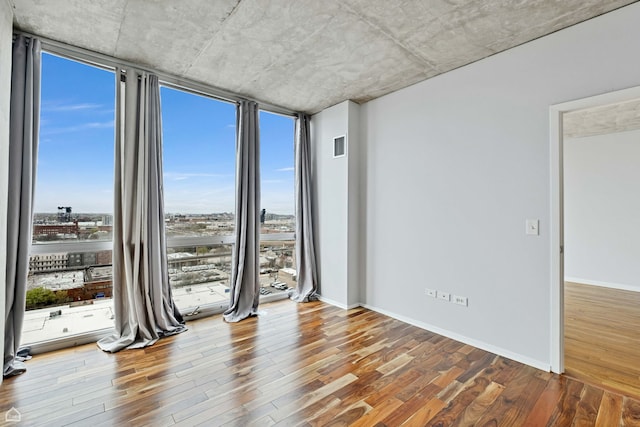1845 S Michigan Ave Unit 1602, Chicago, IL 60616 - empty room featuring floor to ceiling windows, wood finished floors, and baseboards