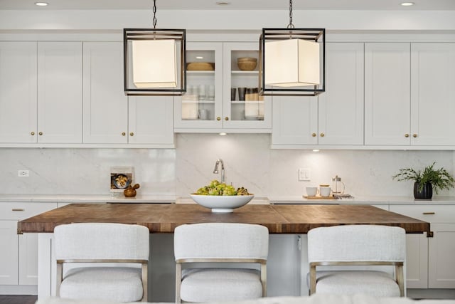 1307 W Wrightwood Ave Unit 201, Chicago, IL 60614 - kitchen with wood counters, decorative backsplash, white cabinets, and recessed lighting