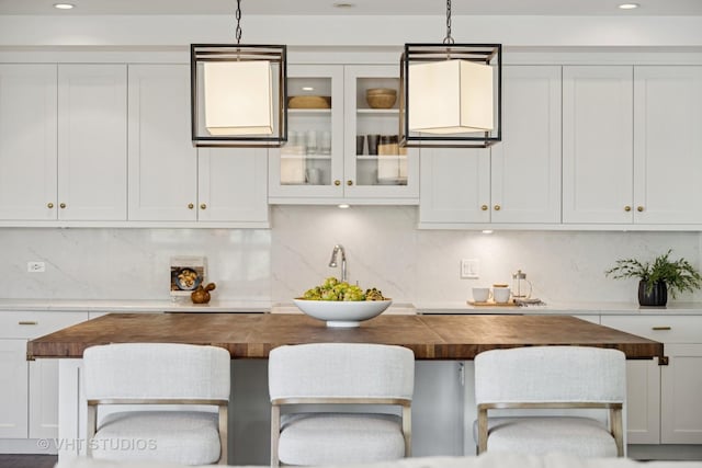 1307 W Wrightwood Ave Unit 201, Chicago, IL 60614 - kitchen featuring butcher block countertops, tasteful backsplash, hanging light fixtures, and recessed lighting