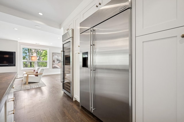 1307 W Wrightwood Ave Unit 201, Chicago, IL 60614 - kitchen featuring stainless steel built in refrigerator, dark wood finished floors, white cabinets, recessed lighting, and dark countertops
