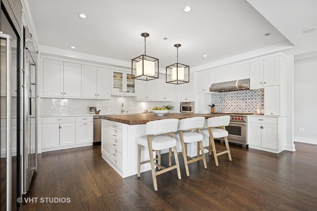 1307 W Wrightwood Ave Unit 201, Chicago, IL 60614 - kitchen featuring wall chimney exhaust hood, stainless steel appliances, wooden counters, recessed lighting, and decorative backsplash