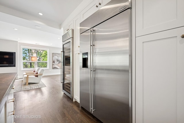 1307 W Wrightwood Ave Unit 201, Chicago, IL 60614 - kitchen with stainless steel built in fridge, dark wood finished floors, white cabinetry, recessed lighting, and dark countertops