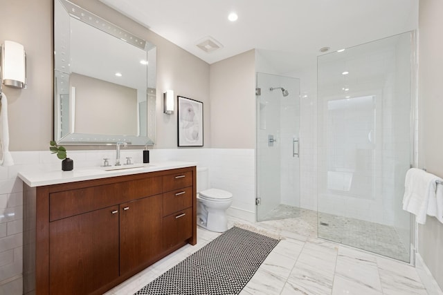 1307 W Wrightwood Ave Unit 201, Chicago, IL 60614 - bathroom featuring a stall shower, vanity, tile walls, recessed lighting, and wainscoting