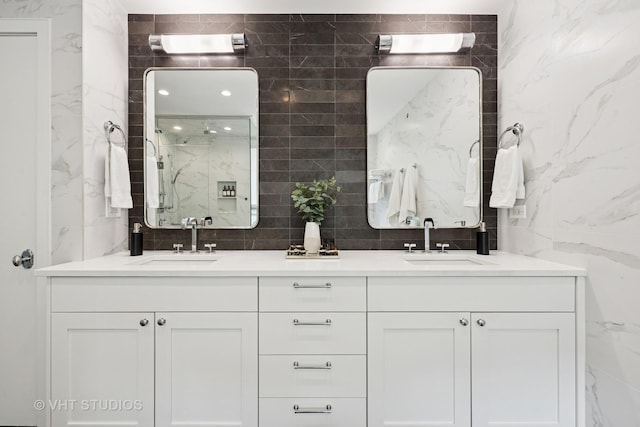1307 W Wrightwood Ave Unit 201, Chicago, IL 60614 - bathroom with a marble finish shower, double vanity, and tile walls