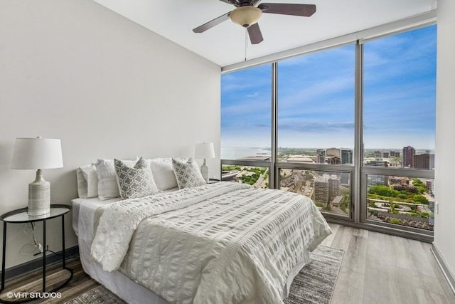 1235 S Prairie Ave Unit 3605, Chicago, IL 60605 - bedroom with expansive windows, wood finished floors, a view of city, and a ceiling fan
