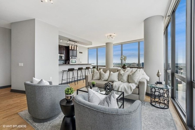 1235 S Prairie Ave Unit 3605, Chicago, IL 60605 - living area with light wood-style flooring, baseboards, and a chandelier