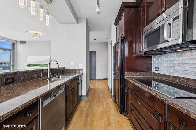 1235 S Prairie Ave Unit 3605, Chicago, IL 60605 - kitchen featuring stainless steel appliances, a sink, dark stone countertops, light wood-style floors, and tasteful backsplash