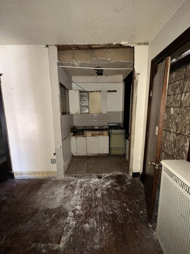 7425 S Harvard Ave, Chicago, IL 60621 - unfurnished living room featuring wood-type flooring and radiator heating unit
