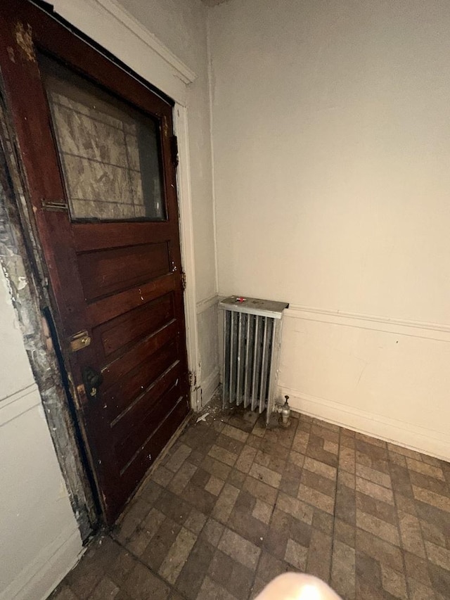7425 S Harvard Ave, Chicago, IL 60621 - unfurnished room featuring radiator heating unit and brick patterned floors