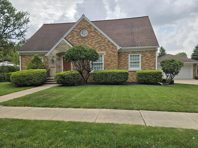 210 S Ridge St, Shannon, IL 61078 - view of front facade with roof with shingles, a front lawn, brick siding, and a garage