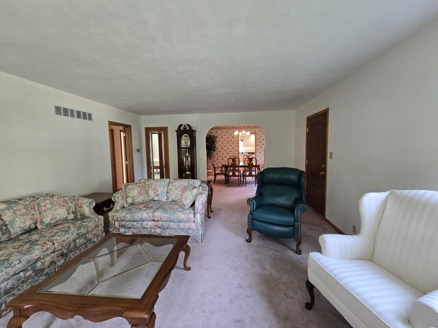 210 S Ridge St, Shannon, IL 61078 - living room featuring a chandelier, carpet, and arched walkways