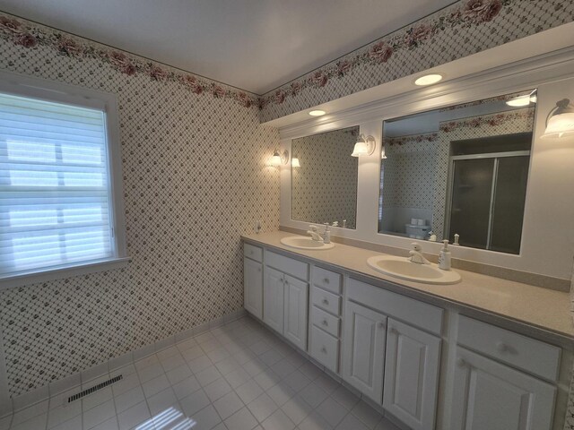 210 S Ridge St, Shannon, IL 61078 - bathroom with double vanity, tile patterned flooring, a stall shower, wallpapered walls, and toilet