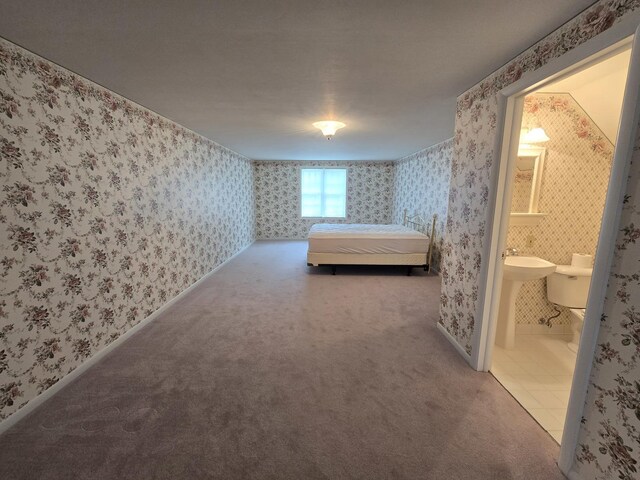 210 S Ridge St, Shannon, IL 61078 - unfurnished bedroom featuring wallpapered walls, connected bathroom, carpet, and baseboards