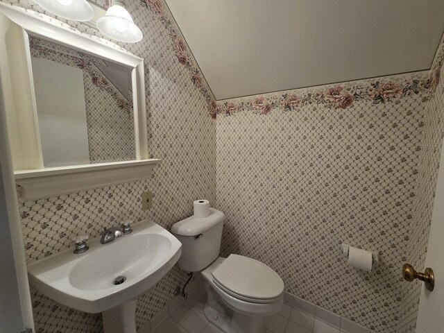 210 S Ridge St, Shannon, IL 61078 - half bath featuring toilet, tile patterned flooring, a sink, tile walls, and wainscoting