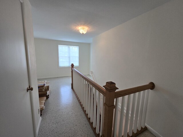 210 S Ridge St, Shannon, IL 61078 - corridor featuring an upstairs landing, baseboards, and dark speckled floor