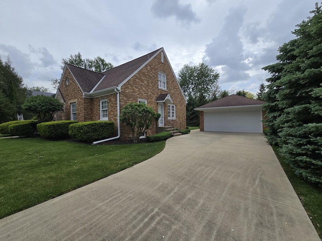 210 S Ridge St, Shannon, IL 61078 - view of front of house with brick siding, a detached garage, an outbuilding, and a front lawn