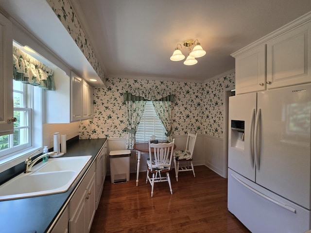 210 S Ridge St, Shannon, IL 61078 - kitchen with white refrigerator with ice dispenser, wallpapered walls, wainscoting, dark wood-style flooring, and white cabinetry