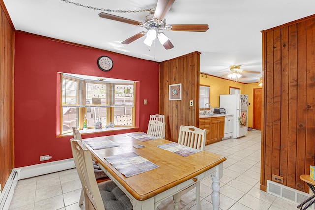 32638 S Lia Ln, Beecher, IL 60401 - dining space with ceiling fan, light tile patterned flooring, a baseboard heating unit, ornamental molding, and wood walls