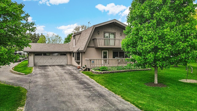 32638 S Lia Ln, Beecher, IL 60401 - dutch colonial with asphalt driveway, an attached garage, a front lawn, a balcony, and a gambrel roof