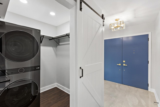 7729 W 157th Pl, Orland Park, IL 60462 - laundry area with stacked washer / drying machine, a barn door, wood finished floors, baseboards, and recessed lighting