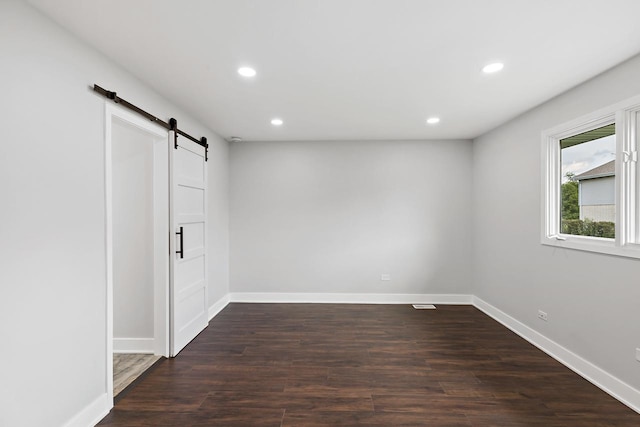 7729 W 157th Pl, Orland Park, IL 60462 - unfurnished room featuring a barn door, recessed lighting, dark wood-style floors, and baseboards
