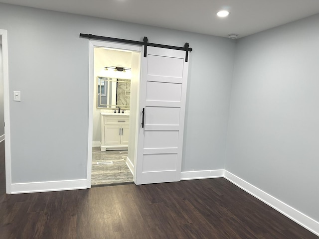 7729 W 157th Pl, Orland Park, IL 60462 - spare room featuring dark wood-style flooring, a barn door, baseboards, recessed lighting, and a smoke detector
