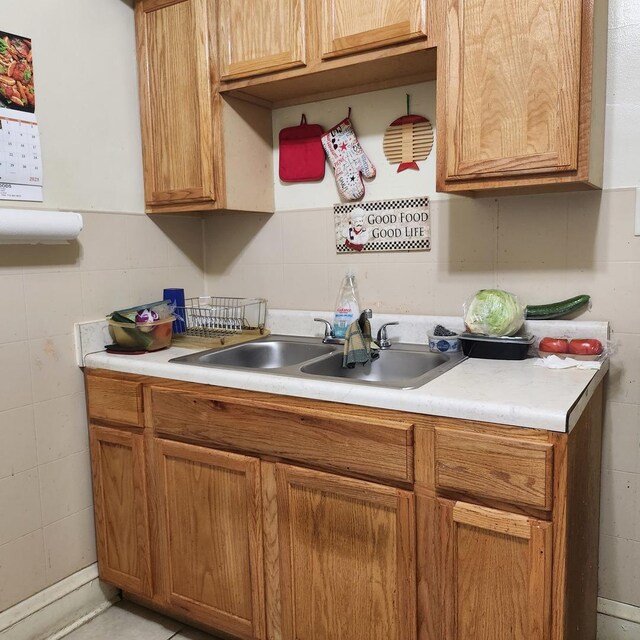 7601 S Morgan St, Chicago, IL 60620 - kitchen with a sink, light countertops, brown cabinets, and tile walls