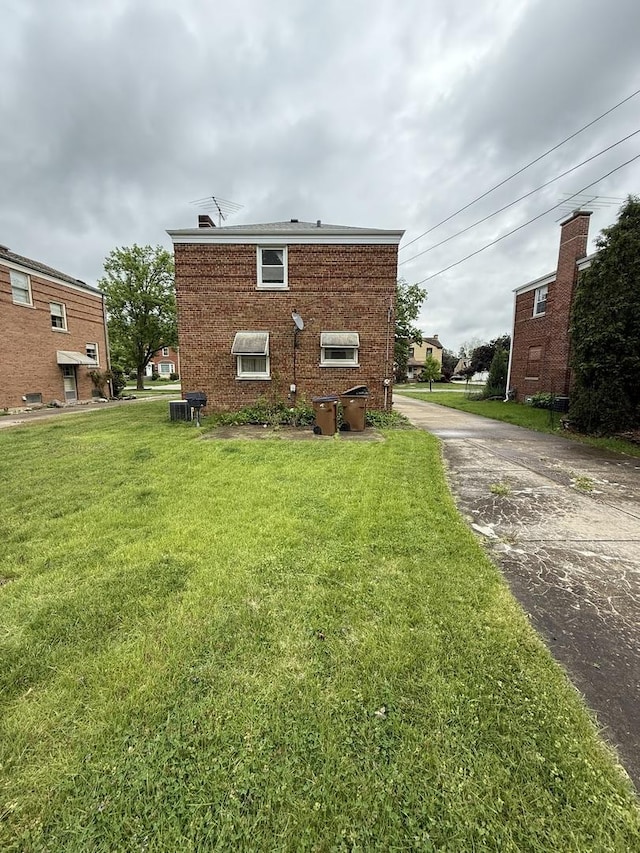 2452 S 6th Ave, North Riverside, IL 60546 - view of home's exterior with a lawn, brick siding, and central AC