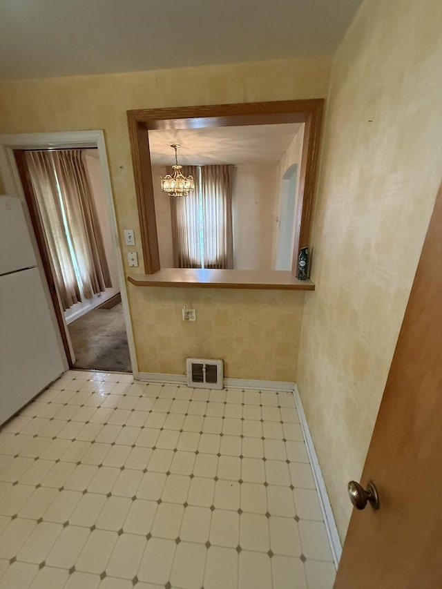 2452 S 6th Ave, North Riverside, IL 60546 - unfurnished dining area featuring tile patterned floors, baseboards, and a chandelier