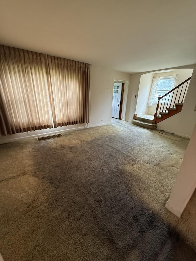 2452 S 6th Ave, North Riverside, IL 60546 - unfurnished living room with carpet flooring, stairway, and baseboards