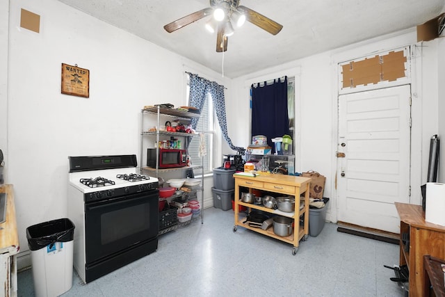 1518 N Kedzie Ave, Chicago, IL 60651 - kitchen featuring black range with gas cooktop and a ceiling fan