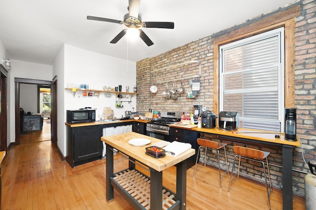 1518 N Kedzie Ave, Chicago, IL 60651 - office area featuring brick wall, ceiling fan, and light wood-style flooring