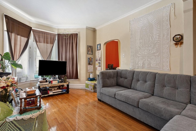 2439 S Millard Ave, Chicago, IL 60623 - living area featuring arched walkways, light wood finished floors, ornamental molding, and baseboards
