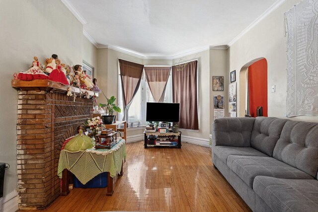 2439 S Millard Ave, Chicago, IL 60623 - living area with arched walkways, wood-type flooring, ornamental molding, and baseboards