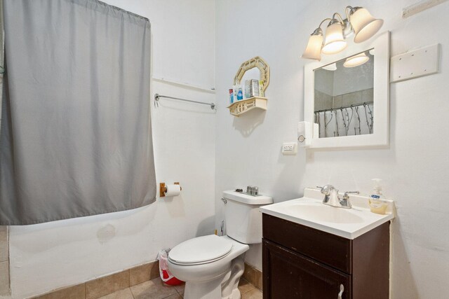 2439 S Millard Ave, Chicago, IL 60623 - bathroom featuring vanity, toilet, tile patterned floors, and curtained shower
