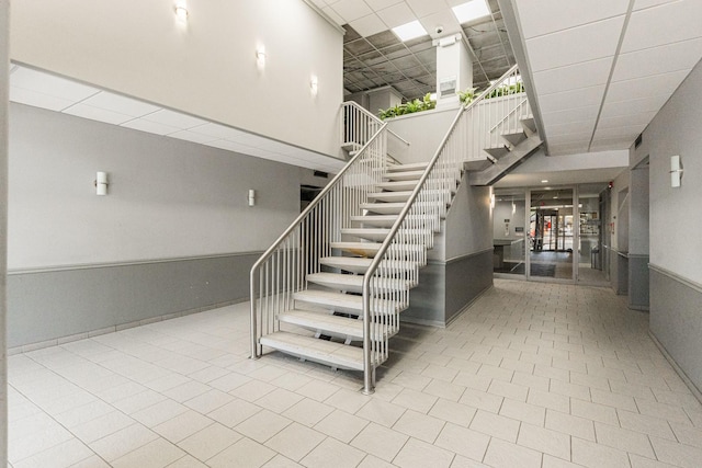 7234 W N Ave Unit 1608, Elmwood Park, IL 60707 - stairs with a towering ceiling and a drop ceiling