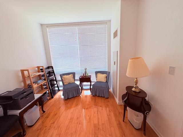 sitting room with light wood-style flooring and baseboards