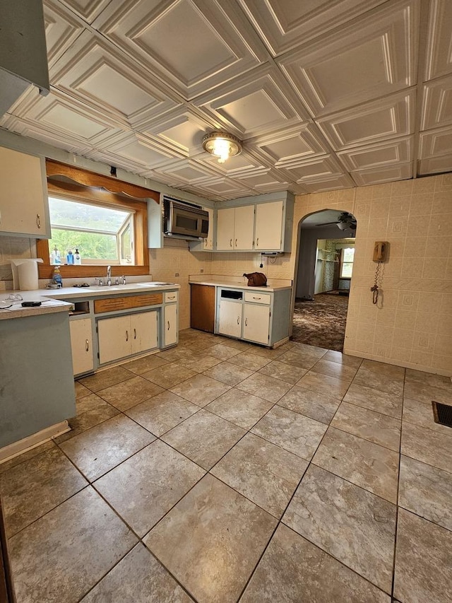 3500 Butler Ave, Steger, IL 60475 - kitchen featuring arched walkways, stainless steel microwave, light countertops, an ornate ceiling, and a sink