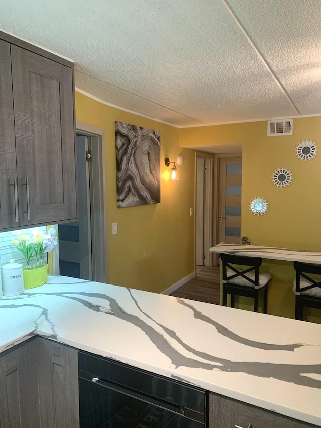 6430 W Belle Plaine Ave Unit 202, Chicago, IL 60634 - kitchen featuring a textured ceiling, beverage cooler, and wood finished floors
