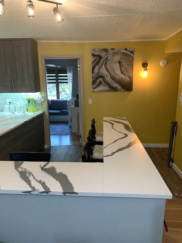 6430 W Belle Plaine Ave Unit 202, Chicago, IL 60634 - kitchen featuring dark wood-style flooring, a textured ceiling, and light countertops