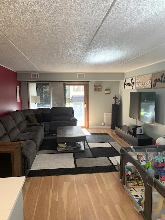 6430 W Belle Plaine Ave Unit 202, Chicago, IL 60634 - living room featuring wood finished floors and a textured ceiling