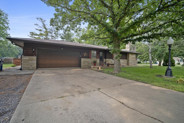 211 S E St, Hudson, IL 61748 - view of front facade featuring stone siding, a front lawn, a garage, driveway, and a chimney